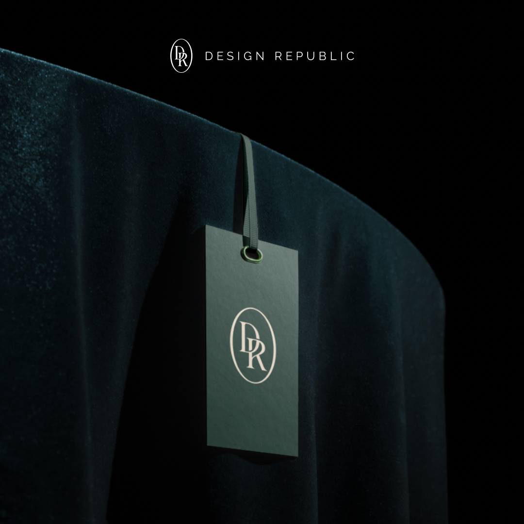 Full service 8 A sleek black tag with the DR logo hangs on a luxurious dark green velvet fabric, symbolizing an exclusive design subscription. The text DESIGN REPUBLIC is elegantly displayed above in minimalist style, set against a dark background.